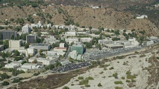 AX0159_080 - 7.6K aerial stock footage of a Jet Propulsion Laboratory campus against the hillside, Pasadena, California