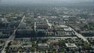AX0159_101E - 7.6K aerial stock footage flying by Pasadena City Hall, office buildings, and 134 freeway, Pasadena, California