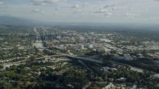 AX0159_104E - 7.6K aerial stock footage flying over an office building to approach Pasadena City Hall, California