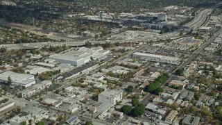 AX0159_111 - 7.6K aerial stock footage of office buildings and a large warehouse beside I-210 in Pasadena, California