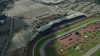 AX0159_118 - 7.6K aerial stock footage flying by and away from Santa Anita Park horse race track in Arcadia, California