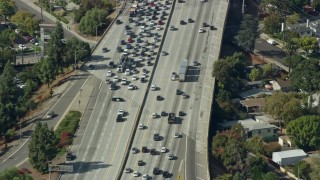 AX0159_120E - 7.6K aerial stock footage of a reverse view of traffic stopped by CHP on 210 Freeway in Arcadia, California