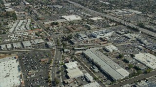 AX0159_122 - 7.6K aerial stock footage flying over a retail area and car dealerships in Monrovia, California