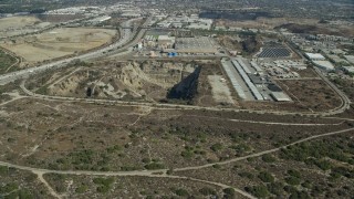 AX0159_125 - 7.6K aerial stock footage of an open pit next to a brewery in Irwindale, California