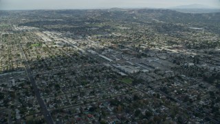 AX0159_128E - 7.6K aerial stock footage of city streets, stores and neighborhoods in Covina, California