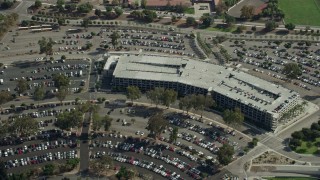 AX0159_132 - 7.6K stock footage aerial video approaching the Cal Poly parking garage in Pomona, California