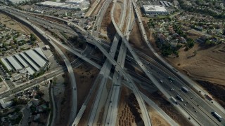 AX0159_135 - 7.6K stock footage aerial video approaching and tilt to light traffic on the Hwy 60 & Hwy 71 Interchange in Pamona, California