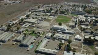 AX0159_146 - 7.6K aerial stock footage flying by the California Institution for Men in Chino, California