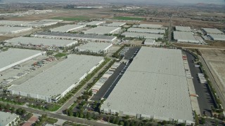 AX0159_152 - 7.6K stock footage aerial video of several warehouses in Chino, California