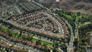 AX0159_153 - 7.6K aerial stock footage approaching and tilt to tract homes in Corona, California