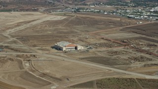 AX0159_167 - 7.6K aerial stock footage of a hangar at an abandoned military airport, Irvine, California