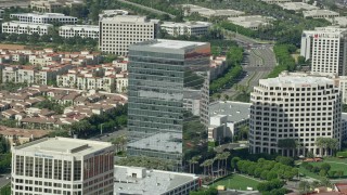 AX0159_170 - 7.6K aerial stock footage orbiting an office building at Irvine Spectrum Center Irvine, California