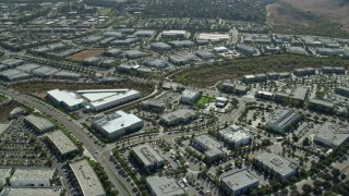 AX0159_175E - 7.6K aerial stock footage flying over and orbit office buildings in a business park, Irvine, California