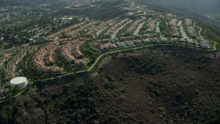 AX0159_182E - 7.6K aerial stock footage flying by hillside homes in Laguna Niguel, California