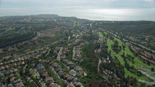 AX0159_184 - 7.6K aerial stock footage of El Niguel Country Club and neighborhoods near the coast in Laguna Niguel, California