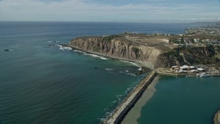 AX0159_198 - 7.6K stock footage aerial video flying over Dana Point Harbor and by clifftop mansions in Dana Point, California
