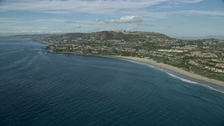 AX0159_201E - 7.6K aerial stock footage flying by homes around Three Arch Bay Beach in Laguna Beach, California