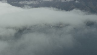 AX0159_247E - 7.6K aerial stock footage of low clouds over Catalina Island, California