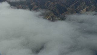 AX0159_249 - 7.6K aerial stock footage of low clouds over Avalon, Catalina Island, California