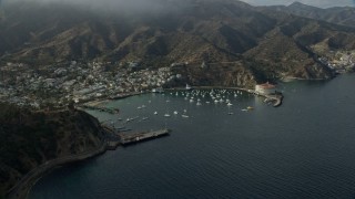 AX0159_257 - 7.6K aerial stock footage of a reverse view of boats anchored in Avalon Bay in Avalon, Catalina Island, California
