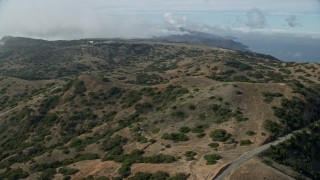 AX0159_270 - 7.6K stock footage aerial video following a road through the hills toward Catalina Airport, Santa Catalina Island, California