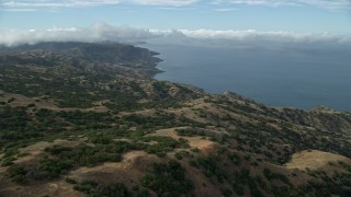 AX0160_001 - 7.6K aerial stock footage flying over hills toward the coast of Santa Catalina Island, California