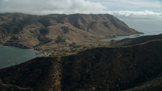 AX0160_010E - 7.6K aerial stock footage of a reverse view of the Two Harbors island community in Santa Catalina Island, California