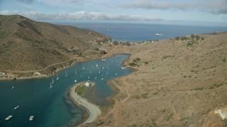 AX0160_016E - 7.6K aerial stock footage flying by Catalina Harbor to approach the island town of Two Harbors, Santa Catalina Island, California
