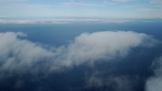 AX0160_022 - 7.6K stock footage aerial video flying over low level clouds over the Pacific Ocean off the coast of Southern California