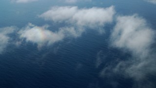 AX0160_028 - 7.6K stock footage aerial video flying over wispy clouds and open water in the Pacific Ocean, Southern California
