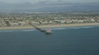 AX0160_039 - 7.6K aerial stock footage of an Huntington Beach Pier and beach in Huntington Beach, California