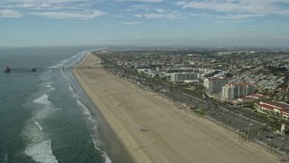 AX0160_040 - 7.6K aerial stock footage of Huntington Beach Pier and Hyatt Regency in Huntington Beach, California