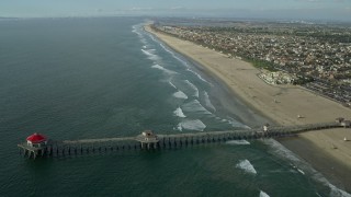 AX0160_041E - 7.6K aerial stock footage of Huntington Beach Pier and the beach in Huntington Beach, California