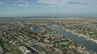 AX0160_050E - 7.6K aerial stock footage approaching the Huntington Harbour residential community in Huntington Beach, California