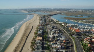 AX0160_052 - 7.6K stock footage aerial video over beachfront homes and highway to approach Seal Beach National Wildlife Refuge, Huntington Beach, California
