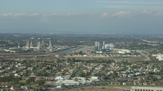 AX0160_054 - 7.6K aerial stock footage of LADWP Haynes Generating Station behind residential neighborhoods in Long Beach, California