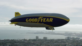 AX0160_065 - 7.6K stock footage aerial video flying around the Goodyear Blimp over Long Beach, California