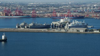 AX0161_010 - 7.6K stock footage aerial video of Sea Launch ship docked near vessels at the Port of Long Beach, California