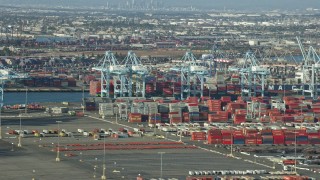 AX0161_013E - 7.6K aerial stock footage of cargo containers and cranes at the Port of Los Angeles, California