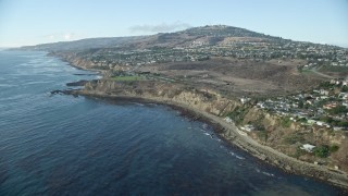 AX0161_017E - 7.6K aerial stock footage tilting from kelp in the ocean to reveal coastal cliffs and neighborhoods in San Pedro, California