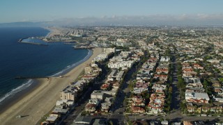 AX0161_035 - 7.6K stock footage aerial video flying over Torrance Beach and pan across Redondo Beach, California to reveal King Harbor Marina