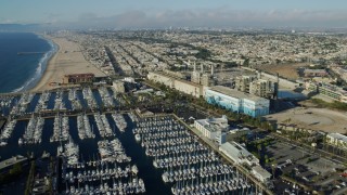 AX0161_037 - 7.6K stock footage aerial video flying over marina and power plant in Redondo Beach, California to approach Hermosa Beach Pier