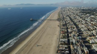 AX0161_040 - 7.6K stock footage aerial video of Manhattan Beach Pier seen while flying over beachside neighborhoods in Manhattan Beach, California