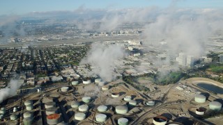 AX0161_043 - 7.6K stock footage aerial video of low level clouds over the Chevron Refinery in El Segundo, California
