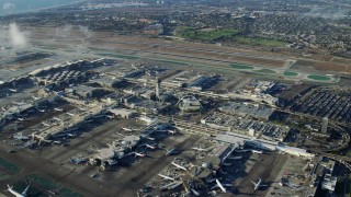 AX0161_046 - 7.6K stock footage aerial video flying over runways toward the control tower and terminals at LAX, California