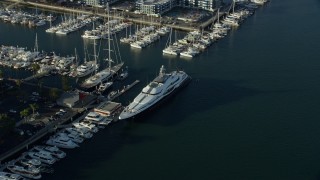 AX0161_059 - 7.6K aerial stock footage of a large yacht docked in Marina Del Rey, California