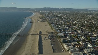 AX0161_060E - 7.6K aerial stock footage flying over the beach toward the Venice Fishing Pier in Venice, California