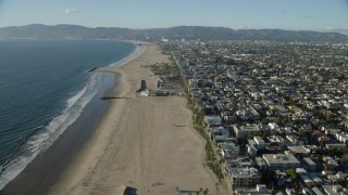 AX0161_061 - 7.6K stock footage aerial video flying over the beach end of the Venice Fishing Pier and Venice Beach in Venice, California