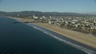 AX0161_067E - 7.6K aerial stock footage flying over beach to approach the Santa Monica Pier, California