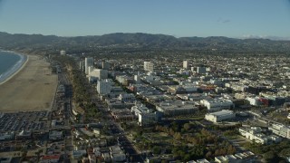 AX0161_069E - 7.6K aerial stock footage flying over the beach to approach shops and Santa Monica Place mall in Santa Monica, California